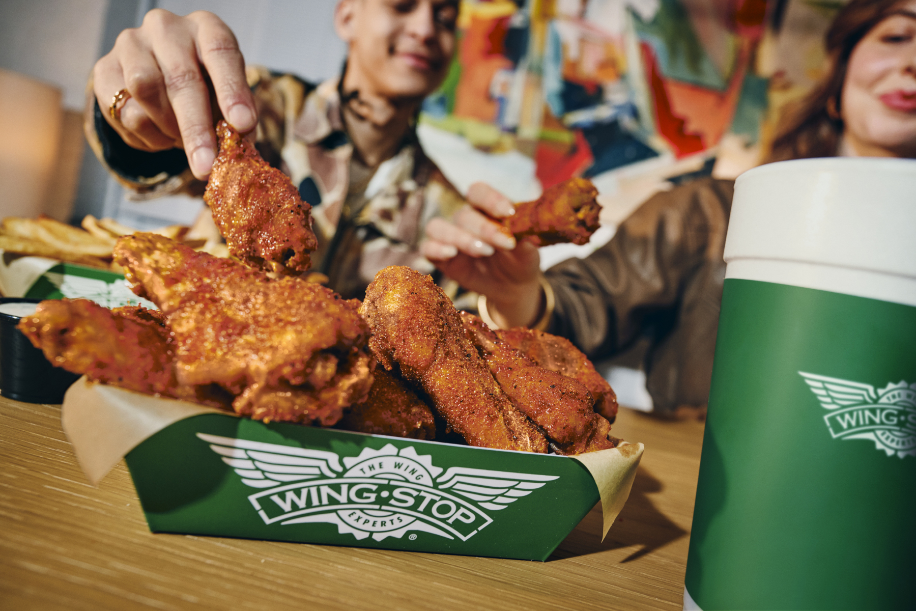 Wingstop Hot Honey classic wings in a branded tray with fries and drinks
